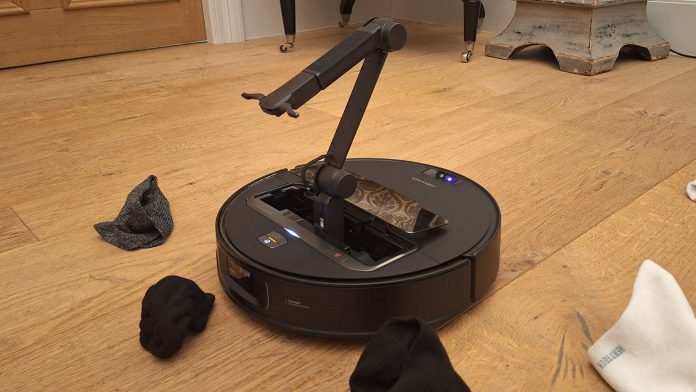 Roborock’s new robovac has a mechanical arm that can acquire your socks and perhaps moreover play alongside with your cat